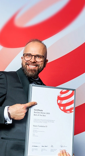 The CEO of Vasco Electronics holding the Red Dot award, showcasing the award-winning devices.